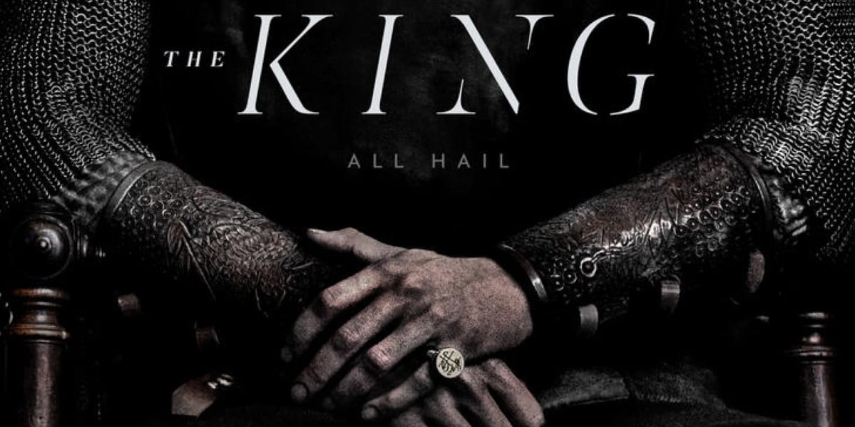 A man's arms with hands folded, wearing chain mail armor and gold ring, with text that reads "The King, All Hail."