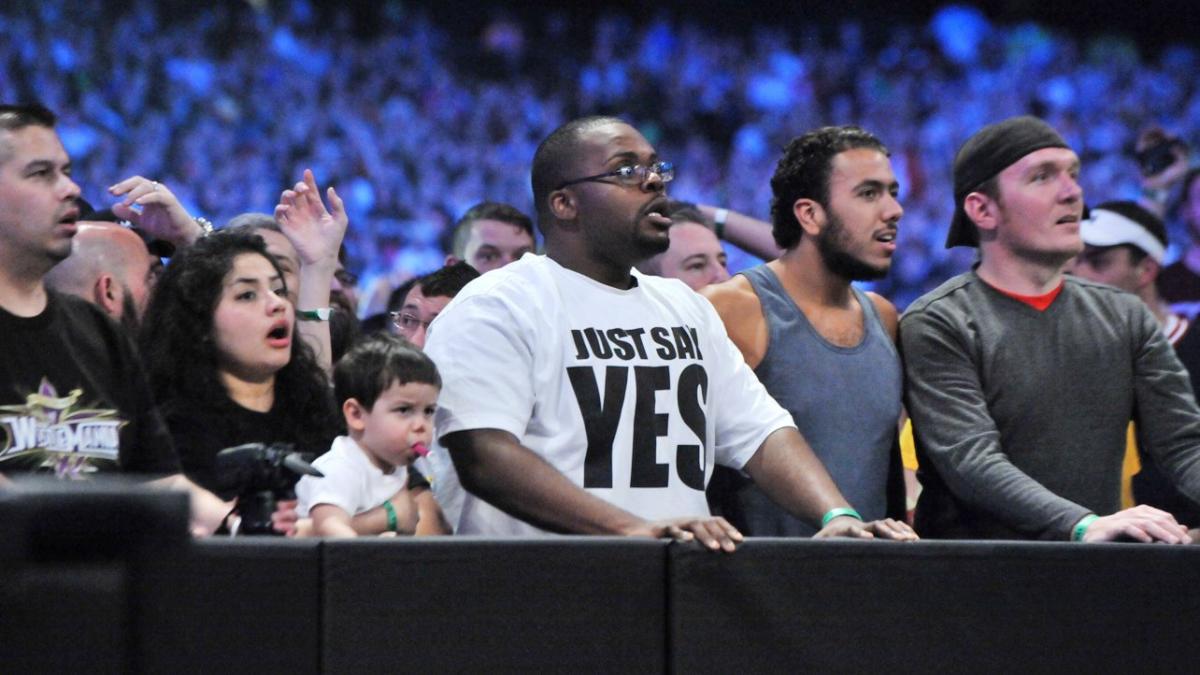 A shocked wrestling fan stares in disbelief