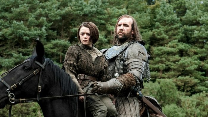 Arya and the Hound ride a horse in the woods