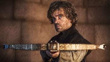 Tyrion Lannister holds a crossbow that is pointed at Tywin (off camera)