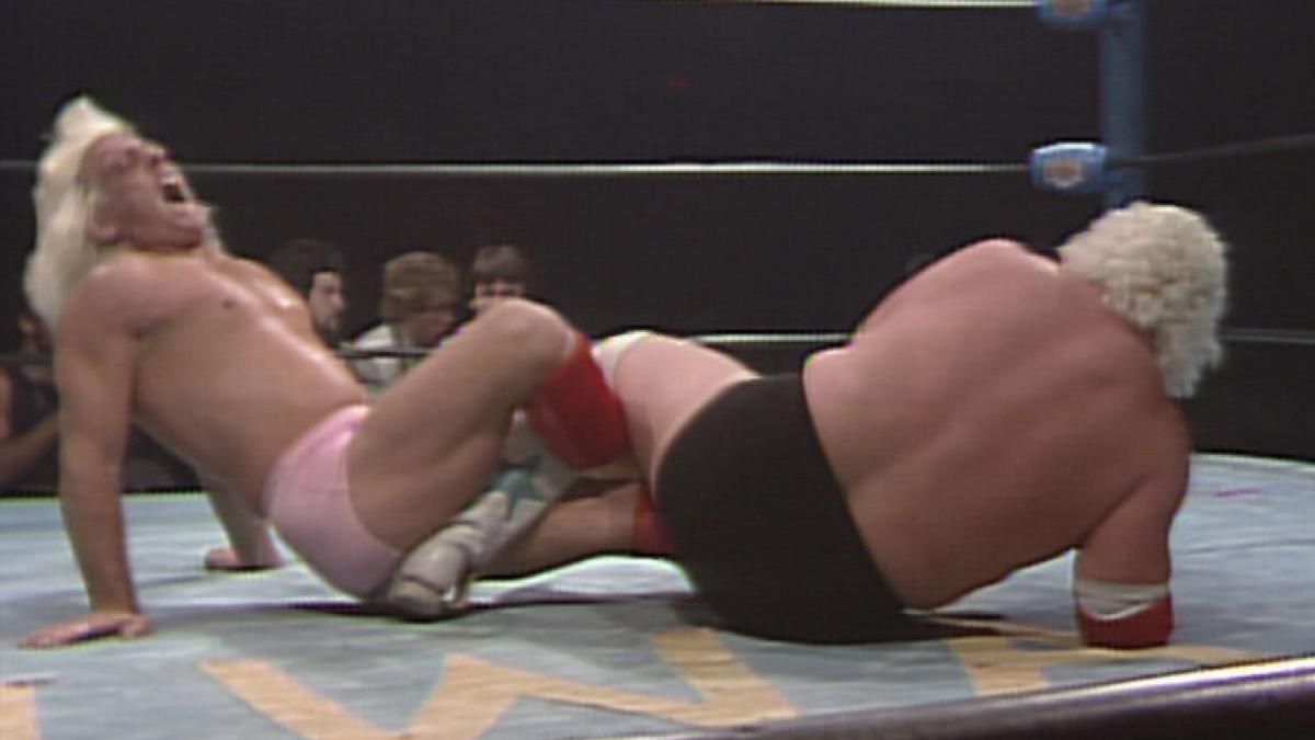 Ric Flair and Dusty Rhodes get tangled in a Figure Four leglock at Starrcade 1984