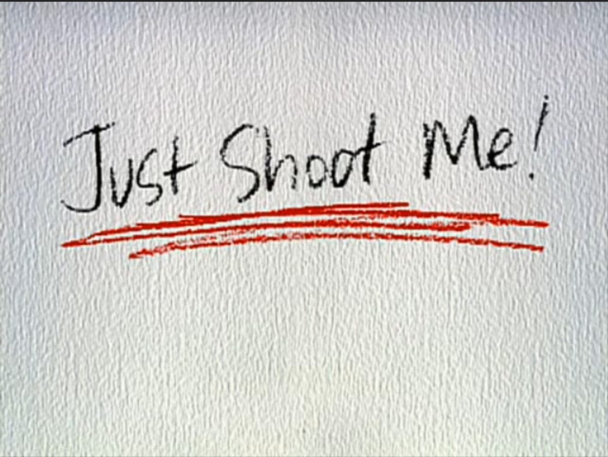 Just Shoot Me written in black and underlined in red