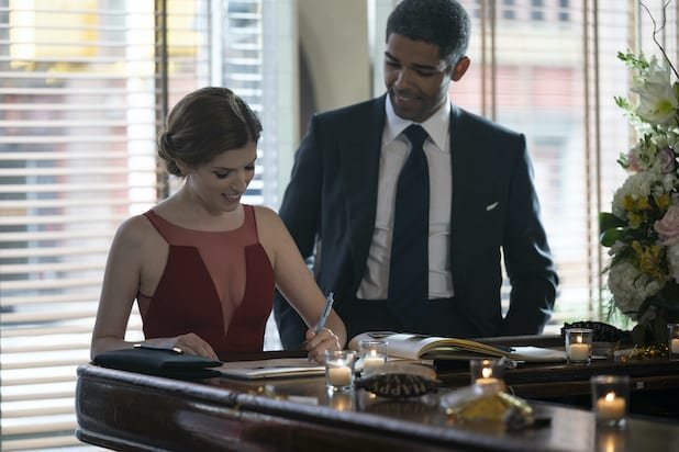 Darby and Grant (Anna Kendrick and Kingsley Ben-Adir) sign a wedding guest book.