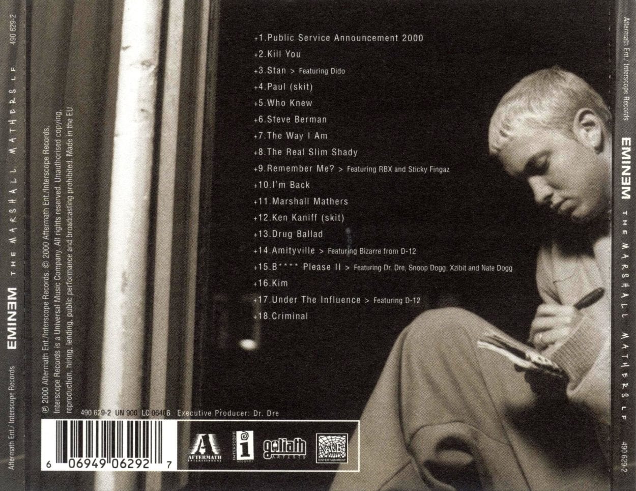 The back cover of The Marshall Mathers LP featuring the track list with Eminem writing on a notepad.