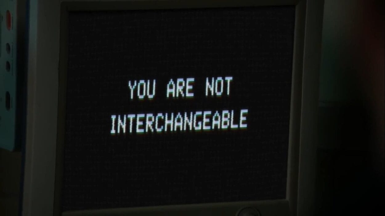 Text on a computer monitor reading "You are not interchangeable"