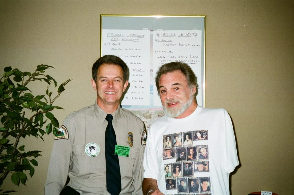 Picture of Bruce Phillips dressed as a Twin Peaks Deputy, posed next to Al Strobel