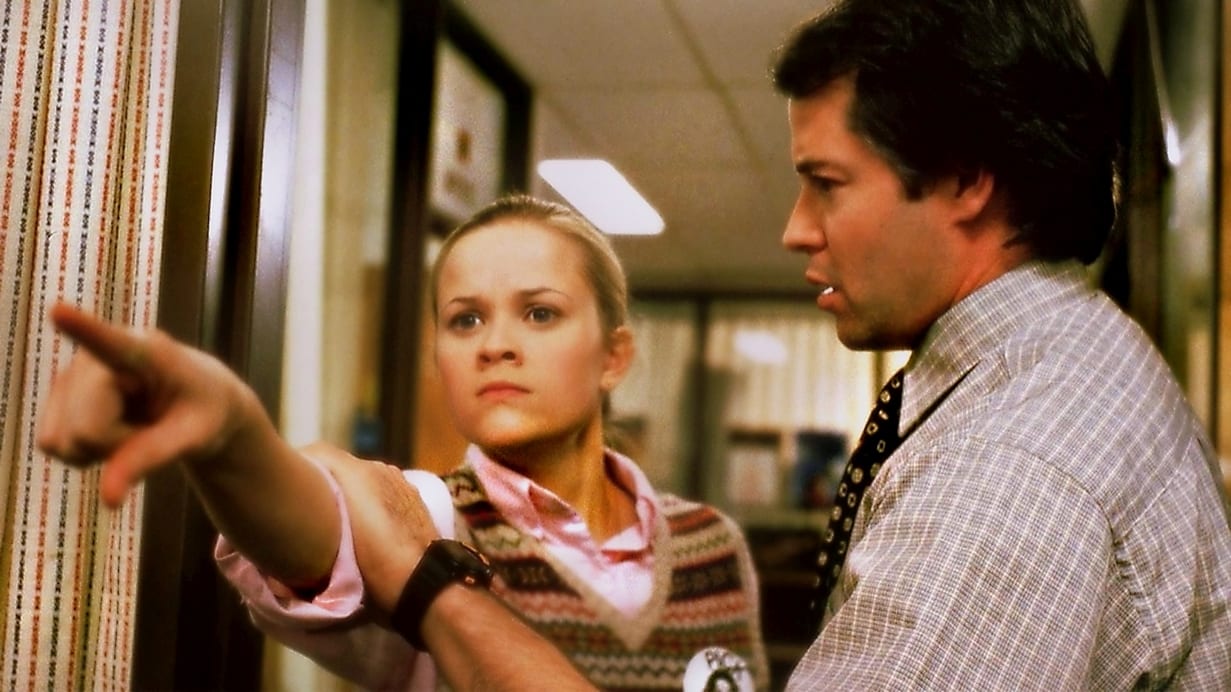 Tracy Flick points angrily at an opponent while Mr. McAllister holds her back