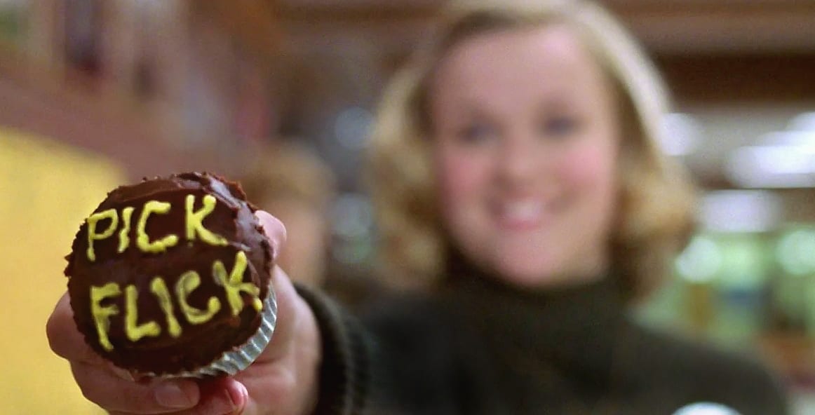 Tracy Flick offers Jim MacAlister a cupcake that with "Pick Flick" written on it