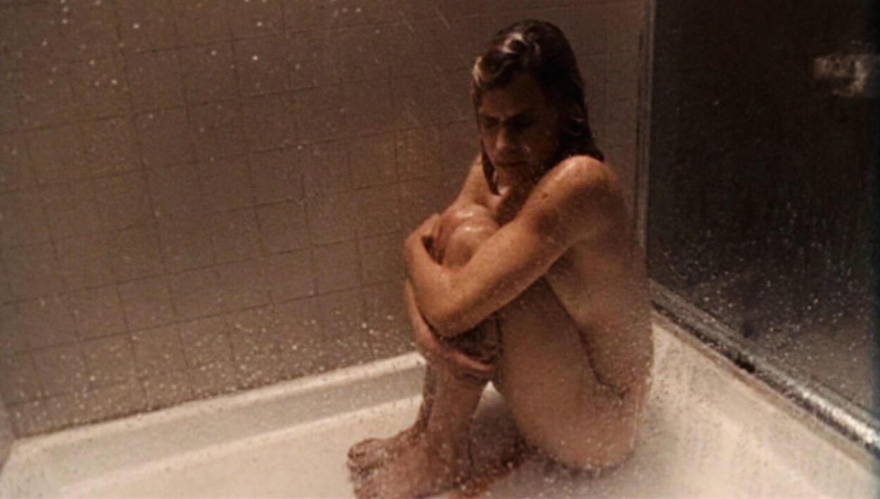 Sera cradles her knees and cries alone in the shower bleeding