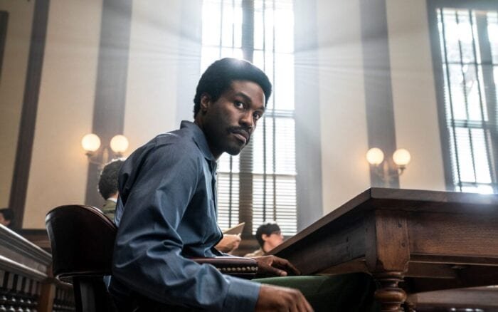 Bobbly Seale looks towards his opposing prosecutors while sitting in court.