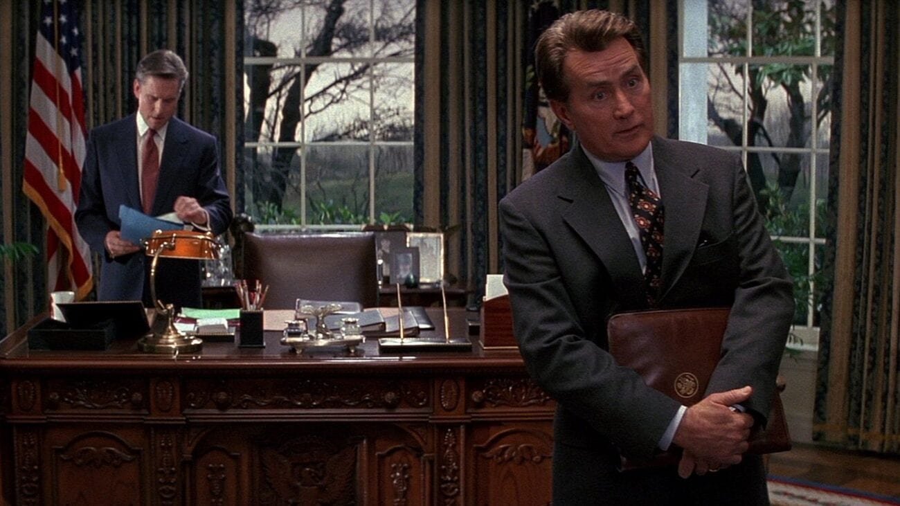 A.J. MacInerney advises a guest addressing the President behind him in the Oval Office.