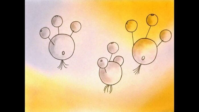 Atop a beige, gray, and golden yellow background, three round creatures float, each with three eyes sticking out of their head on thin tendrils. Two of them display some kind of hole on their side, maybe an eye, and all have little tendrils underneath their bodies much like an octopus.