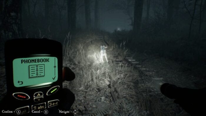 The protagonist of Blair Witch holds a phone and flashlight and looks at his dog in the dark