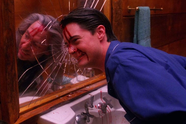 Agent Cooper with BOB in his reflection in the mirror.