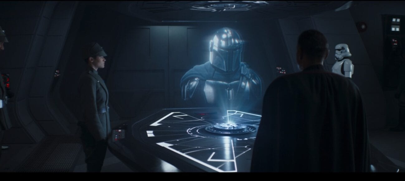 Mando, as a hologram, threatens Moff Gideon, who watches the message