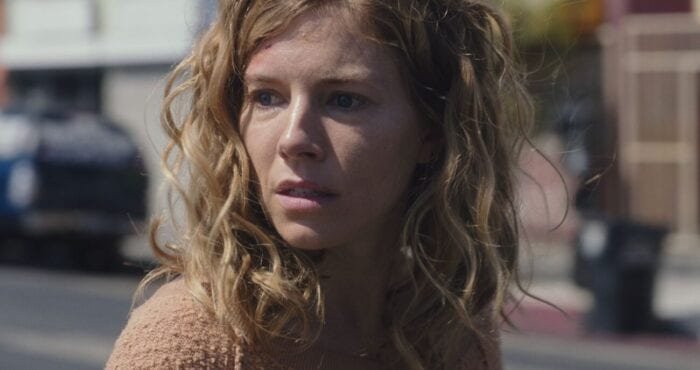 Adrienne turns towards the scene of her accident