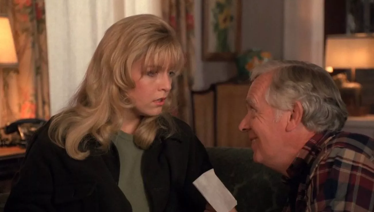 Doc Hayward smiles at an emotional Laura as he reads a comforting message. 