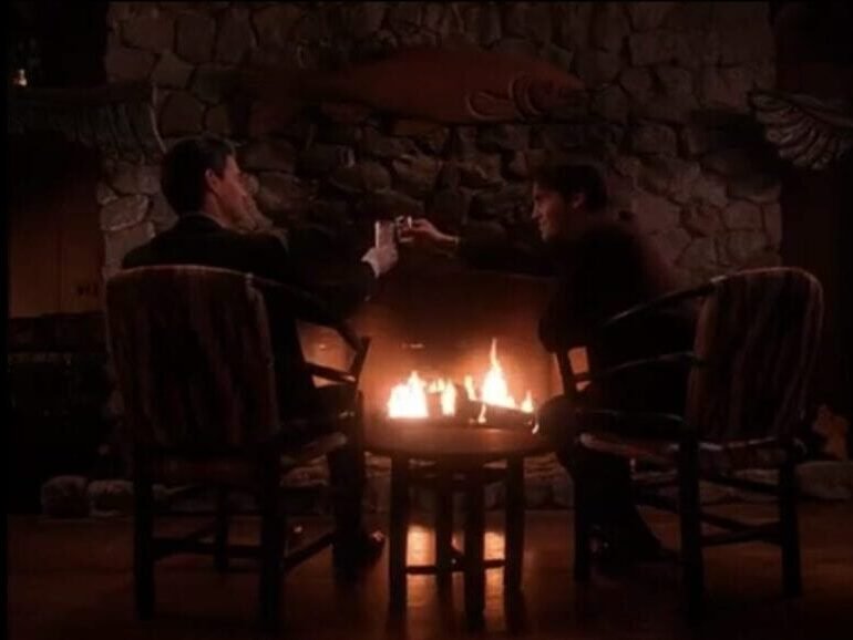 Special Agent Dale Cooper and John Justice Wheeler toast by a fire at the Great Northern