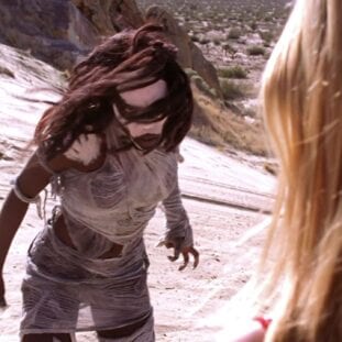 The First Slayer stands in the desert opposite Buffy, inside her dream in Restless
