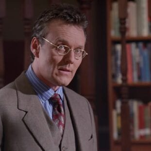 Giles stands in the Sunnydale High School library
