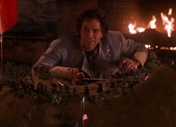 Ben Horne is confident and happy about his civil war figurines battle, and a fireplaces crackles behind him.