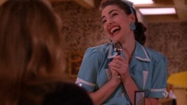 Twin Peaks Episode 24 - Shelley holds a spoon like a microphone, with a big goofy smile on her face