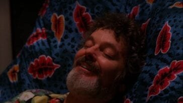 Jacoby smiles with his eyes closed as he is hypnotized