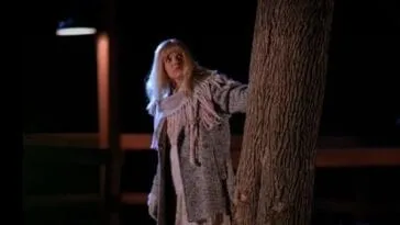 Maddy is dressed as Laura as she stands near a tree