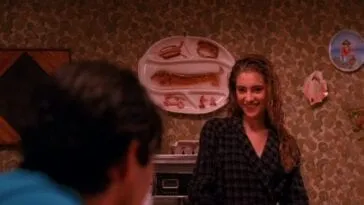 Shelly Johnson serves Bobby Briggs breakfast from the stove.