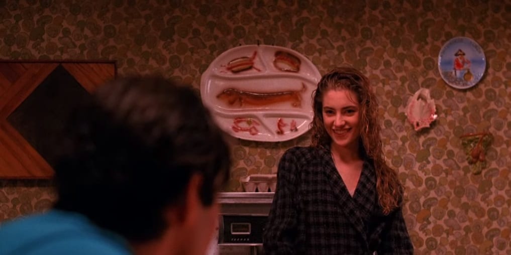 Shelly Johnson serves Bobby Briggs breakfast from the stove.