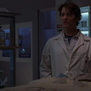 Knox stood in the science lab of Wolfram and Hart wearing his lab coat