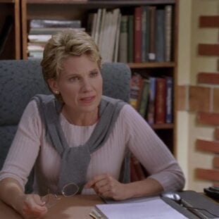 Maggie Walsh sits in her office at UC Sunnydale, looking serious as she consults Buffy