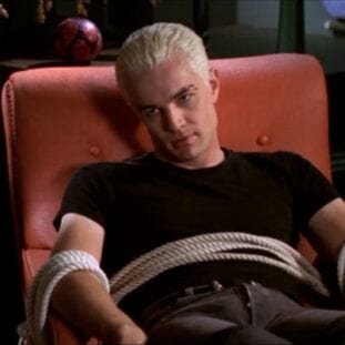 Spike is tied to a chair in Xander's basement, looking very annoyed to be there