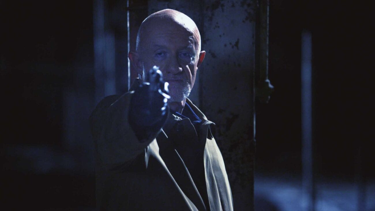 Mike Ehrmantraut aims a revolver off screen in dim lighting