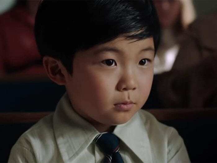 Alan S Kim sits at church