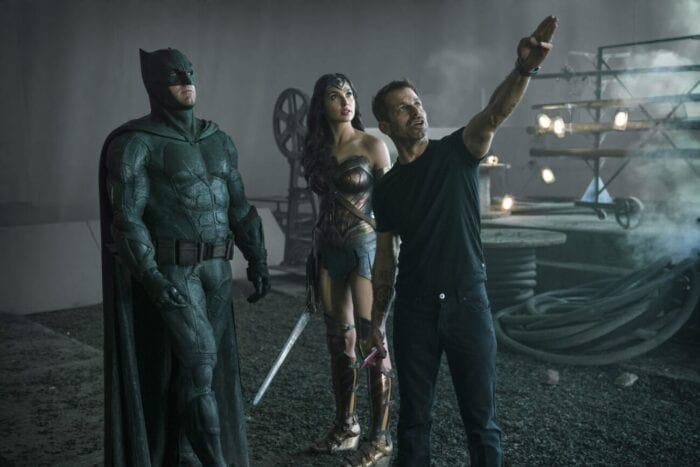 Zack Snyder points to a reference point in front of his costumed actors.
