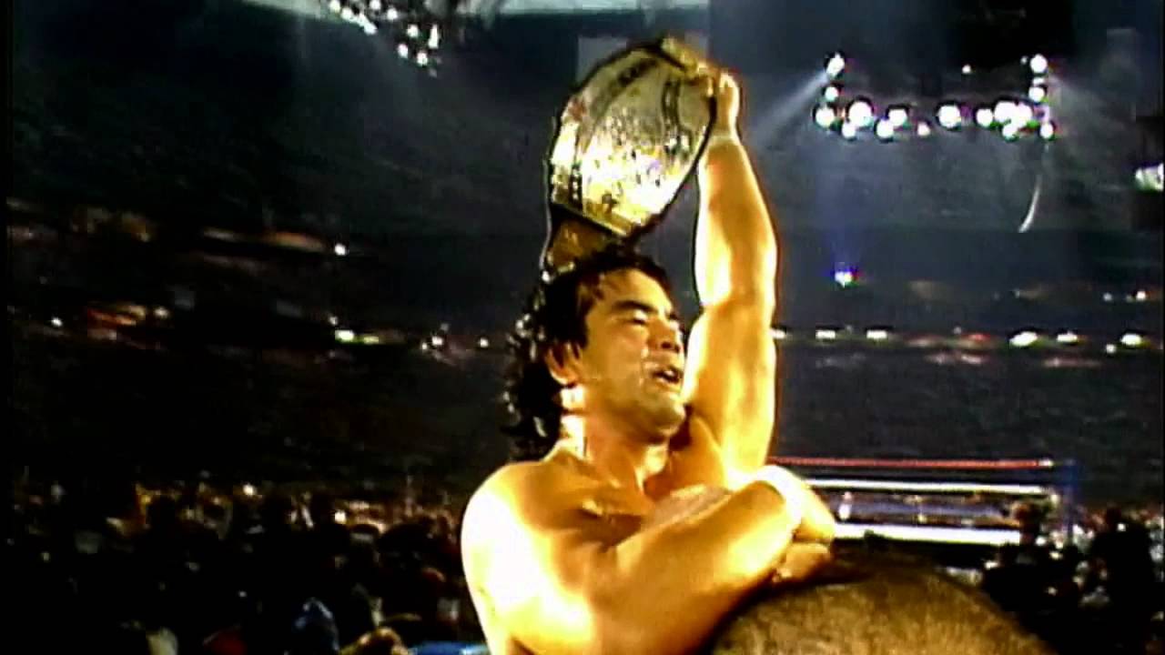Ricky Steamboat holds up the Intercontinental title at WrestleMania 3 as George Steele carries him