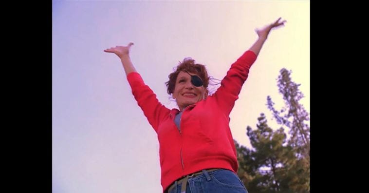 Nadine in red shirt raising arms to sky