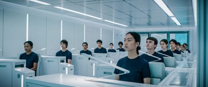 The student crew members watch a video from their workstations.