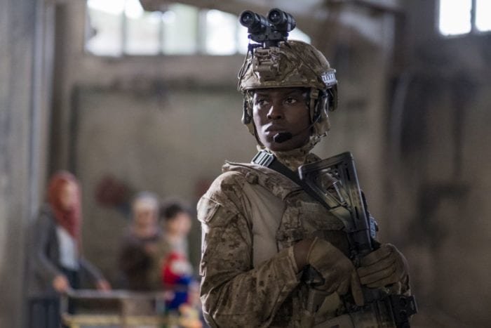 Greer looks over the aftermath in her tactical gear.