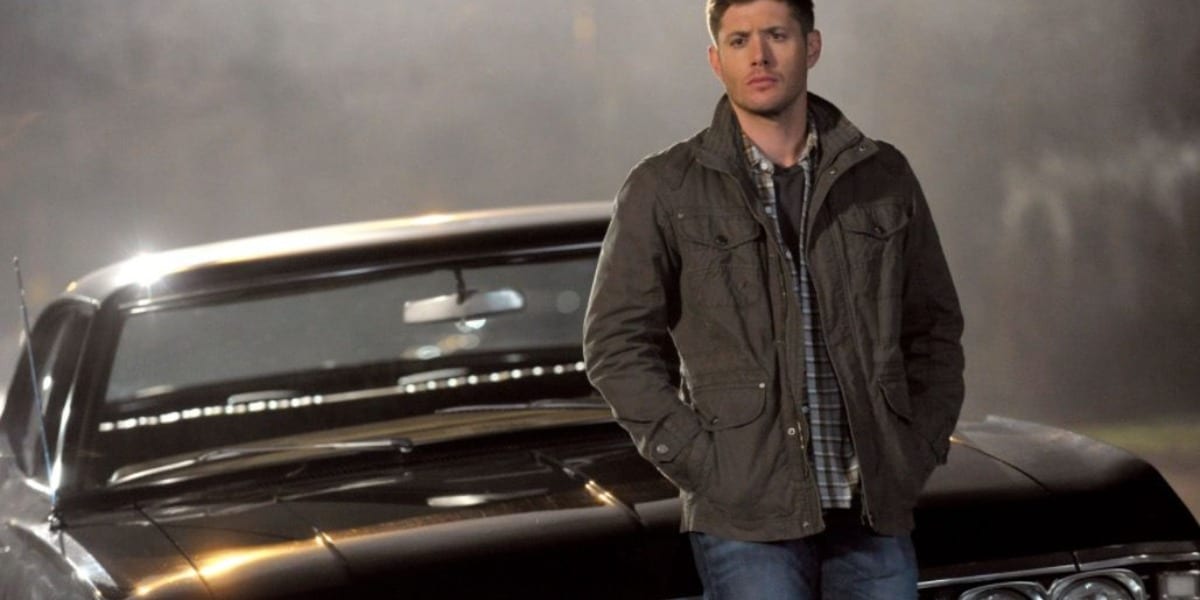Dean leaning on his car Baby, with fog in the background in Supernatural
