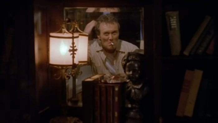 Giles as Ripper looking in the mirror, mussing up his hair as he smokes a cigarette in Buffy the Vampire Slayer