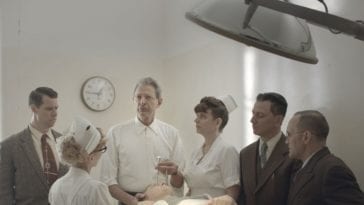 Goldblum's Dr. Wallace oversees a mental patient with his staff, seconds before a lobotomy procedure
