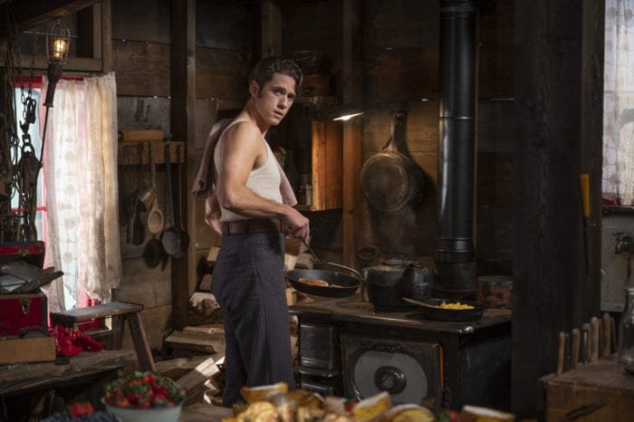Danny Bailey (Aaron Tveit) standing in his ramshackle room looking smolderingly toward the camera