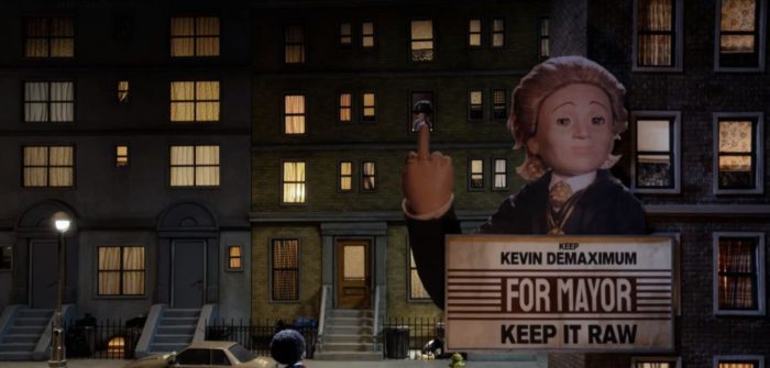 Kevin Demaximum is featured raising a middle finger into the air on a campaign billboard with his name that says Keep It Raw
