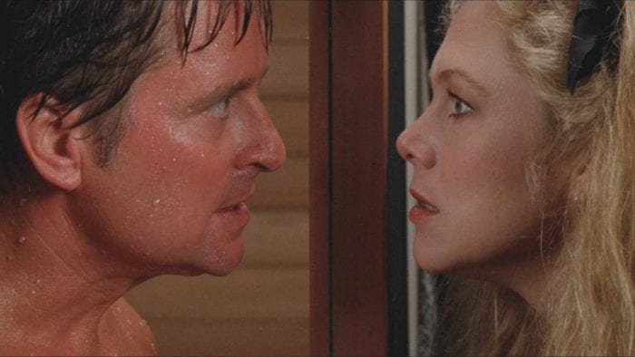 Oliver and Barbra stare at each other though a sauna window