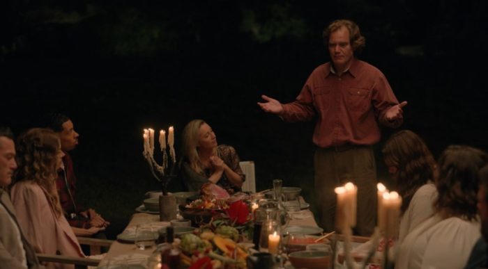 Napoleon Marconi (Michael Shannon) gives his dinner monologue as the Tranquillum guests sit around a candlelit table 