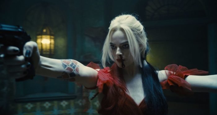 Harley Quinn holds up her two guns for combat.
