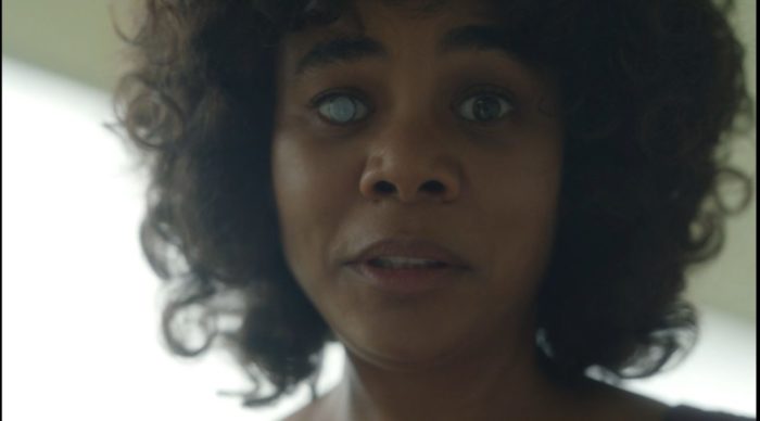 A close up image of Carmel (Regina Hall) with a solid silver coating over her iris in Episode 7, "Wheels on the Bus"