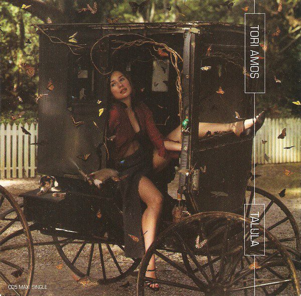 Tori Amos sits in a four-wheeled wooden carriage surrounded by butterflies in the cover photo for the "Talula" single. 